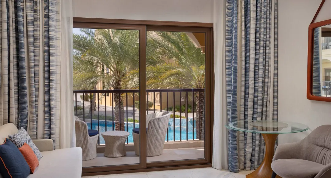Guest Room with Pool View - Balcony Lounge