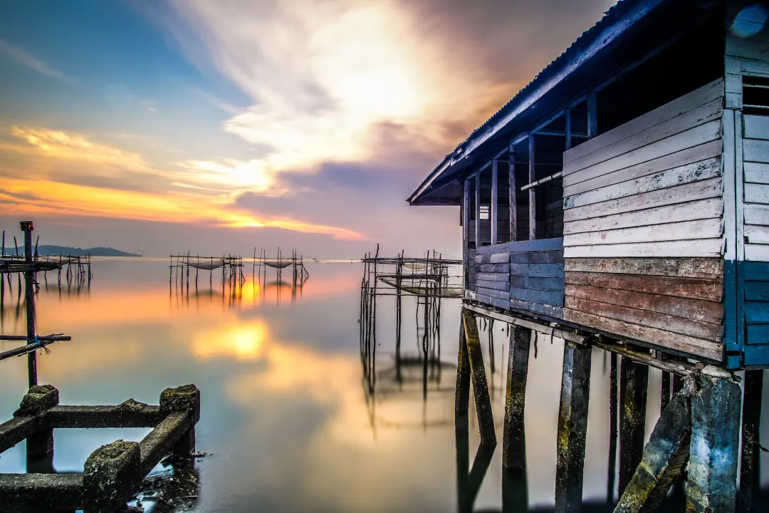 Long exposure of a beautiful sunset at a rural fishing village by the sea in Bintan Island, Riau, Indonesia