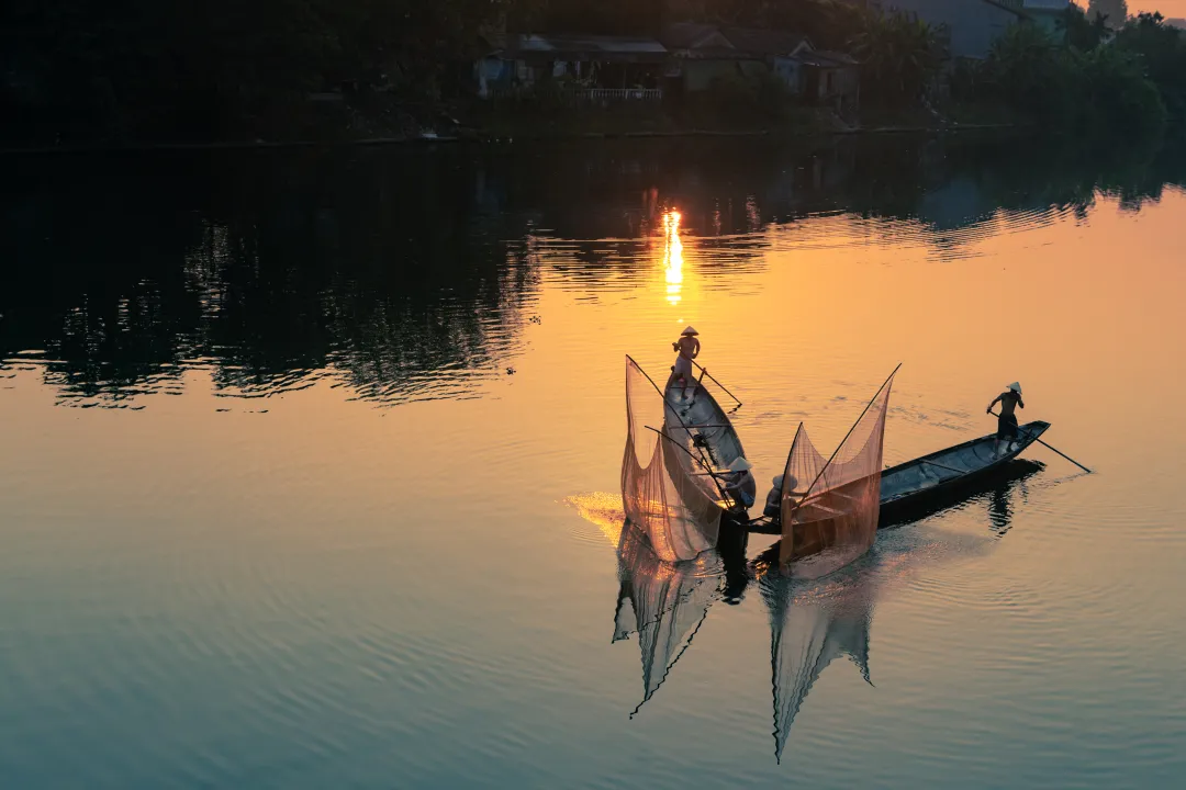 Vietnamese fishermen in famous Perfume River in Hue City, Vietnam