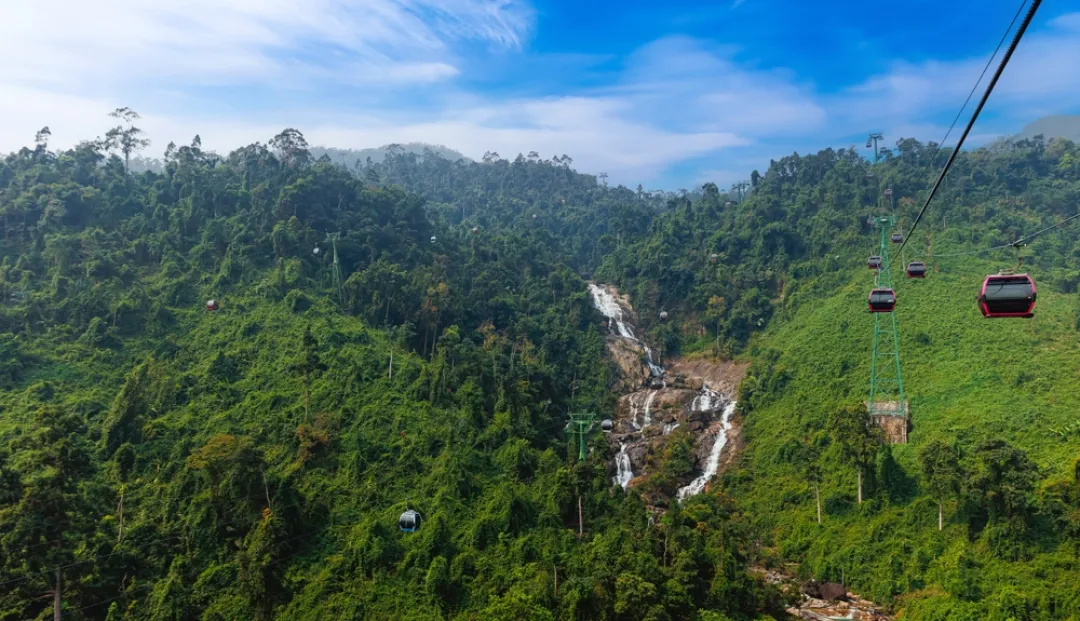 Scenic cable cars over greenery and waterfalls in ba na hills Da nang