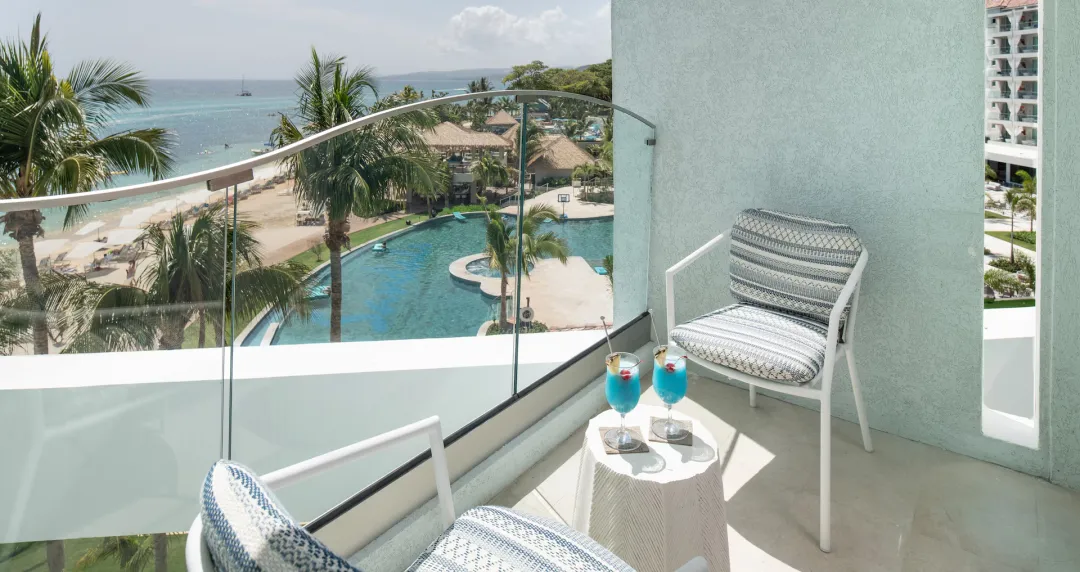 Mammee Bay Oceanview One Bedroom Butler Suite with Balcony Tranquility Soaking Tub - O1B - Balcony Lounge