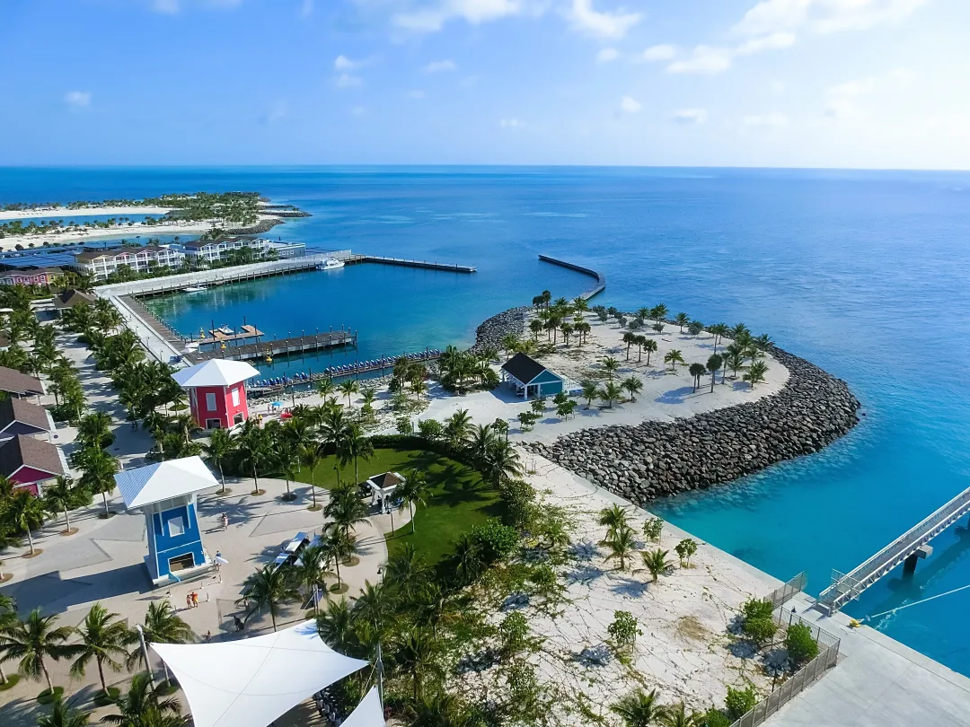 Beach on Ocean Cay Bahamas Island with colorful houses and turquoise water