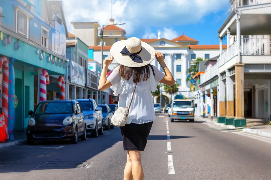 A tourist woman on a sightseeing trip through the colourful streets of Nassau, Bahamas, Caribbean