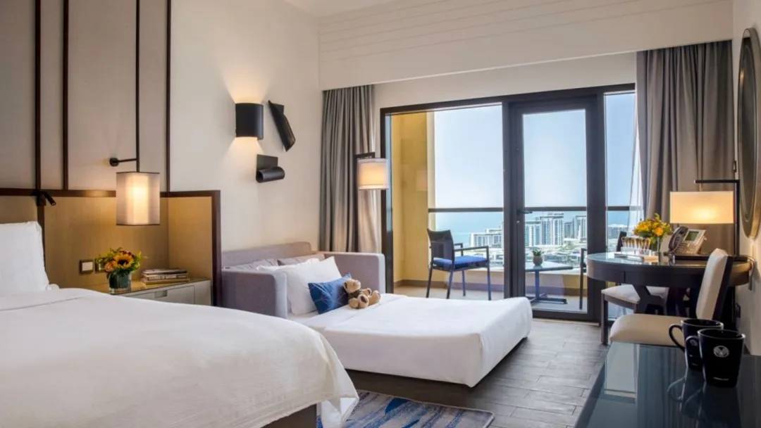 Odysseys Travel - Amwaj Rotana - Rooms - Sea Front View Family Room with Balcony - Bedroom