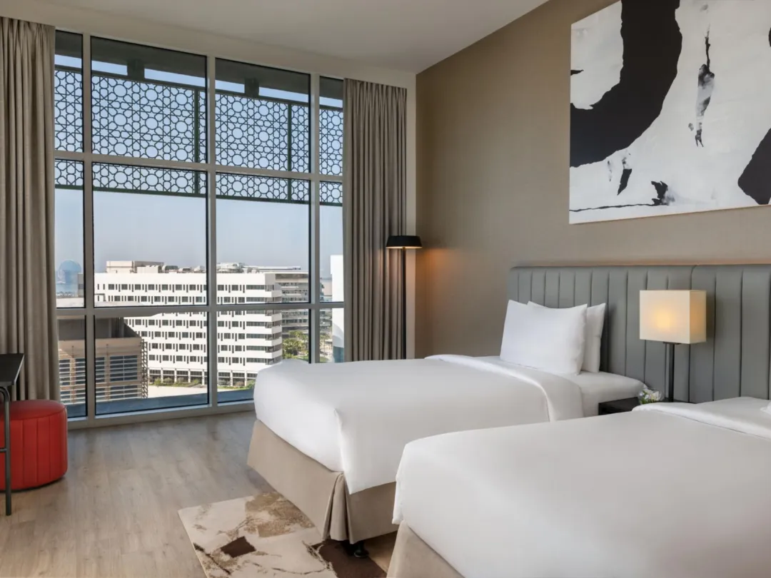 Odysseys Travel - Yas Plaza Marina by IHG - Two Twin Deluxe Plaza View Theme Park Access - Bedroom