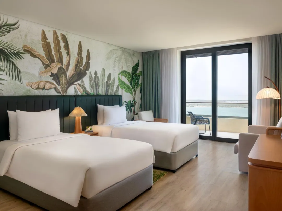 Odysseys Travel - Yas Plaza Mangroves by IHG - Two Twin Deluxe Plaza View Balcony Theme Park Access - Bedroom