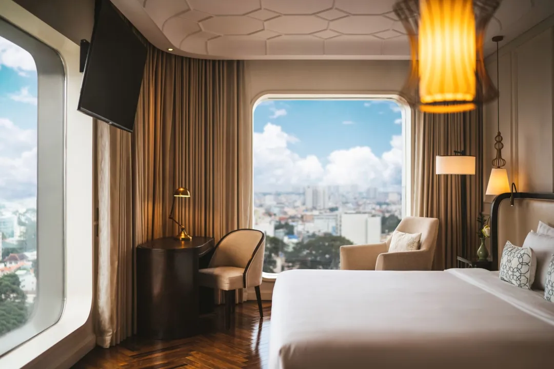 Odysseys Travel - Hotel des Arts Saigon - Rooms - Deluxe Corner Room - Bedroom Window View
