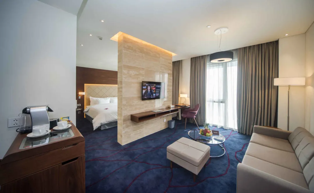 Odysseys Travel - Liberty Central Saigon Riverside - Rooms - Liberty Central Suite - Bedroom and Living Area